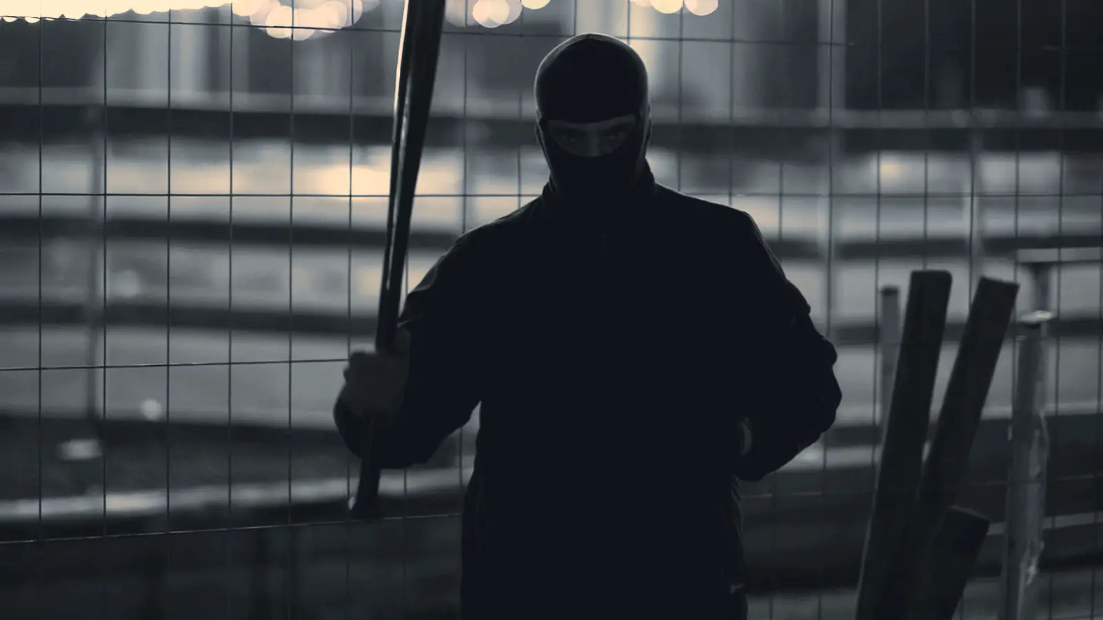 Baseball player holding a bat under the lights